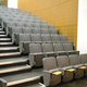 The chairs in this lecture theatre are fitted with writing tablets which fold-away into the arm when not in use. This is ideal in multi-purpose venues where a table may not always be required.